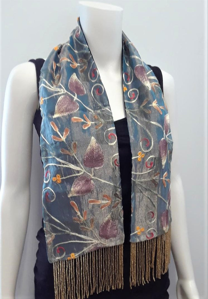 Embroidered scarf with beaded fringe.