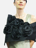 This floral wrap is made of metallic silk organza and features a fold down collar and 5 flowers made of a combination of satin organza and silk organza. The piece is available in all black, for a very dramatic look, but the flowers are also available in colors -  rose, orange and pink.  Another combination is silver with white flowers. It has a snap closure and measures 51" x 16", but as with all the styles, can be customized for larger sizes also.