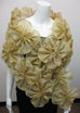 Metallic silk organza wrap made of attached gold flowers providing an opening for the arms;