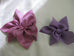 A silk bow pin made of satin faced organza, measuring approximately. May be worn on sweaters, jackets, coats, hats, handbags.