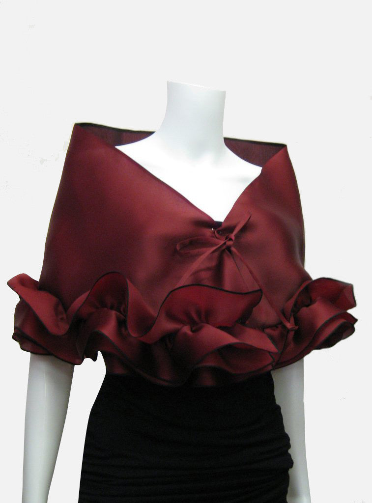 This red burgundy elegant, satin organza evening wrap can be made with a snap closure or with ties, depending on preference. It measures 50" x 15" and can be customized for larger sizes. A beautiful addition to any woman's wardrobe, it features a rouched double ruffle at the bottom. This luxurious piece is the perfect cover up for an evening dress or gown.