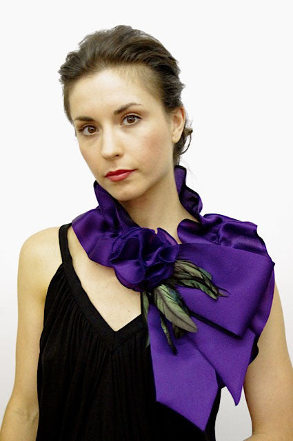 Rouched satin faced organza neck piece with flower and coque feathers; snap closure.
