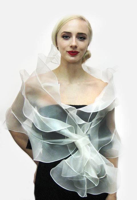 A bridal wrap made from metallic silk organza with 3 tiered ruffles and loop closure