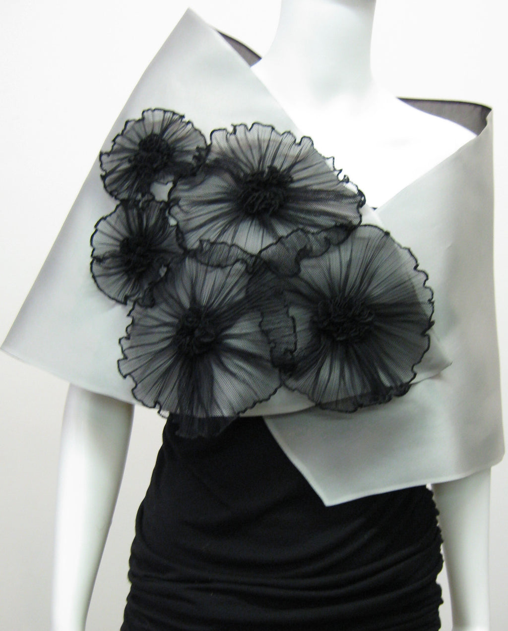 This elegant satin faced organza evening wrap is lined in silk organza and features 5 pleated flowers. 