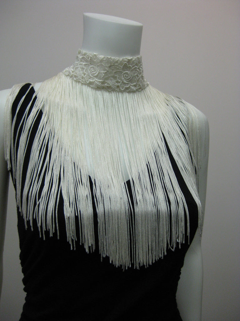 Lace choker with 11" rayon fringe and snap closure. 