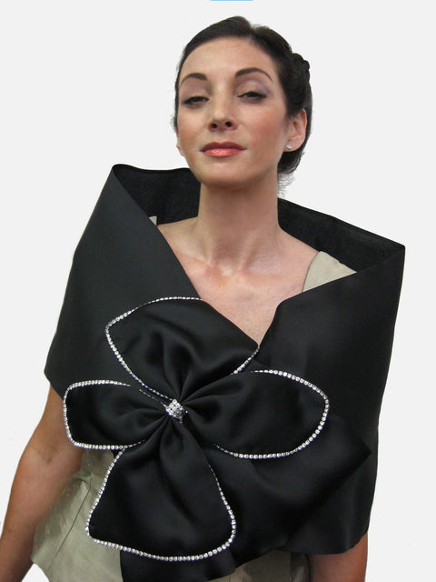 Satin faced organza wrap with large bow and rhinestone trim.  It measures 51" x 14" and has a snap closure.  Dramatic and elegant.
